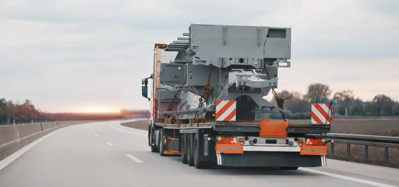 Heavy lift flatbed truck with out-of-gauge cargo.